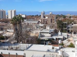 a city skyline with a palm tree and buildings at Centro Suit in San Juan