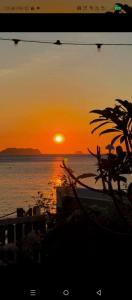 a sunset over a body of water with the sun at The Reef Anilao in Mabini +6 photos
