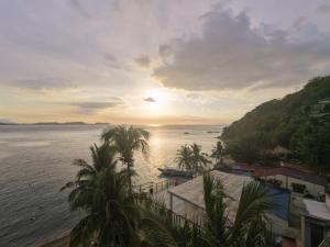 a view of a body of water with palm trees at The Reef Anilao in Mabini