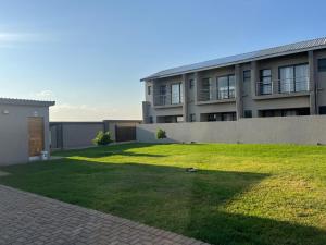 a large building with a lawn in front of it at Lehumo Guesthouse in Mogales