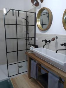 a bathroom with a sink and a mirror at Chambre - A La Maison Du Bonheur in Lanty-sur-Aube