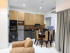 a kitchen and dining room with a table and chairs at Esthella Property in Ijaiye