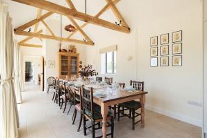 a dining room with a long table and chairs at Scenic Barn Conversion in Rural Shropshire in Craven Arms