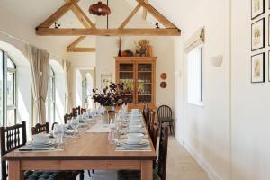 a dining room with a long table and chairs at Scenic Barn Conversion in Rural Shropshire in Craven Arms