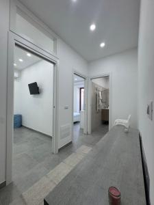 a living room with white walls and a sliding door at La dimora dei Giglianti in Brusciano