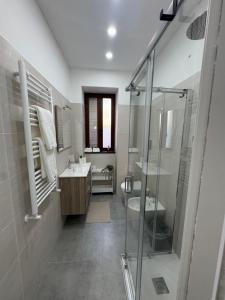 a bathroom with a shower and a sink and a toilet at La dimora dei Giglianti in Brusciano +8 photos