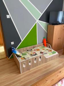 a childs bed in a childs room with at Tuba Apartman in Kiskunhalas