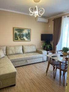 a living room with a couch and a table at Berat Central Home in Berat