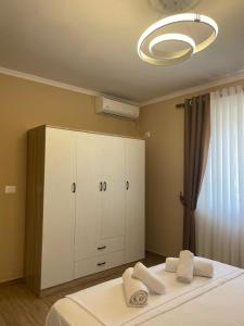 a bedroom with a bed with two towels on it at Berat Central Home in Berat