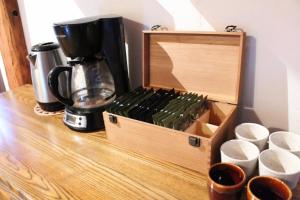 a wooden box sitting on top of a table with cups at Slo-Brome gîte de charme slow life in Lac-Brome +59 photos