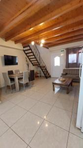 a large living room with a table and a staircase at The Mastiha Spot 5 in Chios