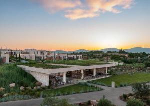 an aerial view of a building with a sunset in the background at Akra Didim Resort & SPA in Didim