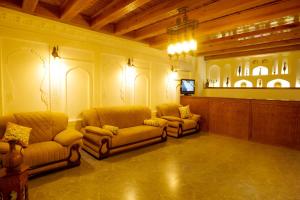 a lobby with two couches and a flat screen tv at Mashkobi Buxoro in Bukhara