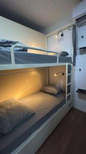 a room with two bunk beds with lights on them at Half Orange in Vagator