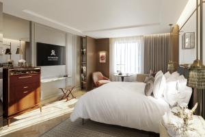 a bedroom with a large white bed and a television at The St. Regis London in London