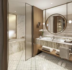 a bathroom with a tub and a sink and a mirror at The St. Regis London in London