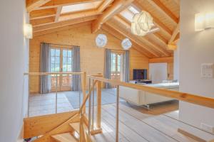 a room with a staircase in a wooden house at Apartment Bränderli - GRIWA RENT AG in Grindelwald
