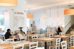 a group of people sitting at tables in a restaurant at Regiohotel Manfredi in Manfredonia