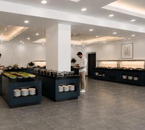 ein Mann steht vor einer Buffetschlange in der Unterkunft Unipark Hotel in Kurna
