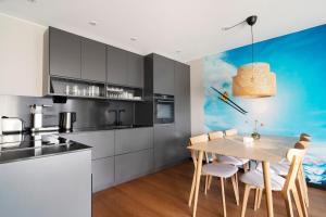 a kitchen with a wooden table and a dining room at View Apartments in Åre