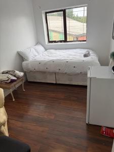 a room with two beds and a window at Cottingley Spring farm house in Leeds +4 photos