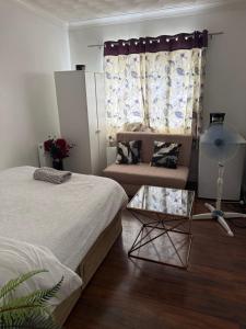 a living room with two beds and a couch at Cottingley Spring farm house in Leeds