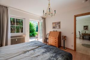 a bedroom with a bed and a dresser and a window at Rai Mattiss in Oberharmersbach