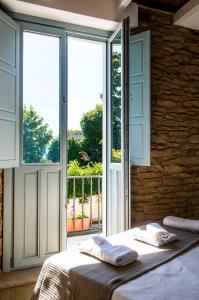 a bedroom with a bed and a large window at A Calexa Sarria nº3 in Sarria