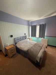a bedroom with a bed and a nightstand and a window at The Fox Inn in Steventon +30 photos