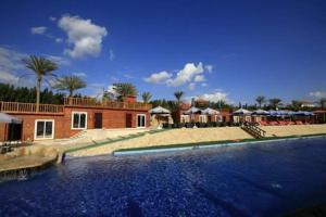 a large swimming pool in front of a house at Kemzo Hotel in Abū Rawwāsh +27 photos