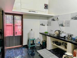 a kitchen with a sink and a counter top at KHS Ranganath-G in Tiruchirappalli