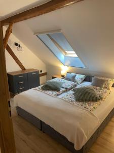 a bedroom with a large bed with a skylight at Agroturystyka u Iwony in Wiekowo