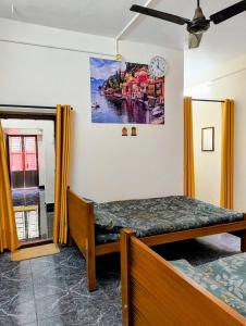 a bedroom with a bed and a painting on the wall at KHS Ranganath-G in Tiruchirappalli