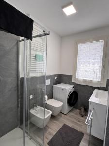 a bathroom with a shower and a toilet and a sink at golf time apartment - Lido di Venezia in Venice +6 photos