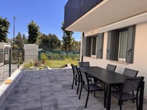 a black table and chairs on a patio at golf time apartment - Lido di Venezia in Venice