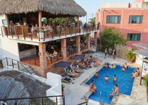 a group of people in a pool at a hotel at Viajero Sayulita Hostel in Sayulita