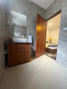 a bathroom with a sink and a mirror at Simple Belle Stay ,Pool &Bar in Vagator