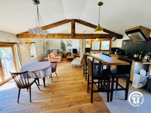 a kitchen and dining room with a table and chairs at Gîte de la jument rousse in Lagrasse