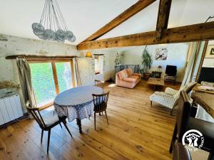 a large living room with a table and chairs at Gîte de la jument rousse in Lagrasse +12 photos