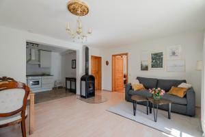 a living room with a couch and a stove at Rai Mattiss in Oberharmersbach