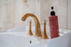 a sink with a faucet and a bottle of soap at Rai Mattiss in Oberharmersbach +20 photos