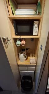 a small kitchen with a sink and a microwave at Port Nan Gael Pods in Pennyghael