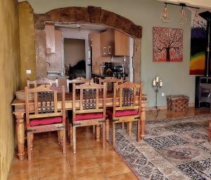a dining room with a wooden table and chairs at Quinta Cabecinha in Penela