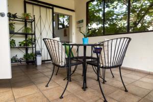 a table and two chairs on a porch at Arbol de Fuego Eco-hotel in San Salvador