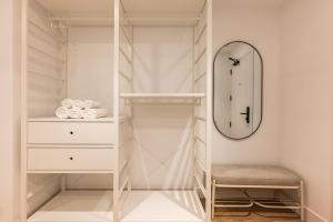 a walk in closet with a mirror and a stool at Cauce 4 Apartments in Torremolinos +180 photos