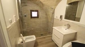 a bathroom with a shower and a toilet and a sink at Mastropaolo42 Luxury B&B in Grottaglie +30 photos