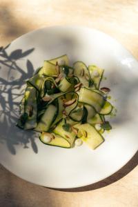 a white plate of food with vegetables on it at Château de Valmer in La Croix-Valmer +82 photos