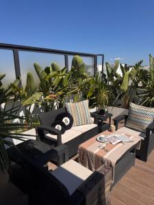 a balcony with couches and a table and plants at Le Chill Out in Tunis
