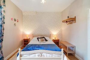 a bedroom with a white bed and two night stands at Maison De Campagne in Ligneyrac
