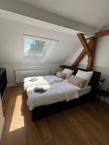 a bedroom with a large bed with a window at Ferienwohnung König in Brandenburg an der Havel